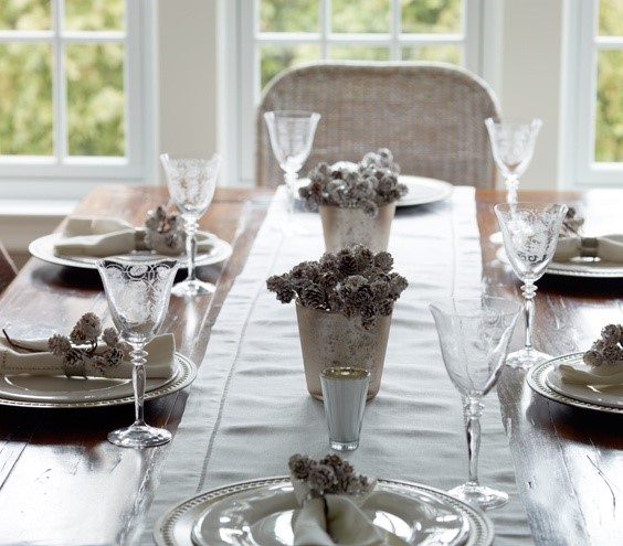 White table settings with pinecone center pieces